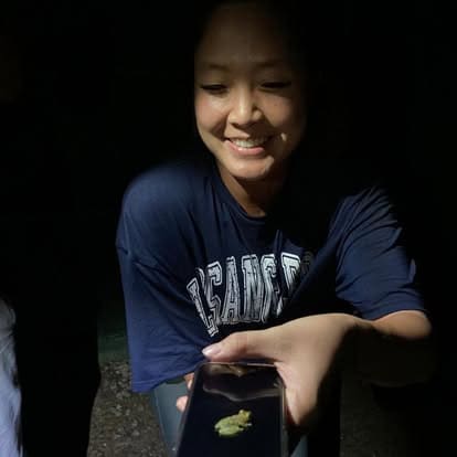 Guest observing a frog during the night tour in Arenal