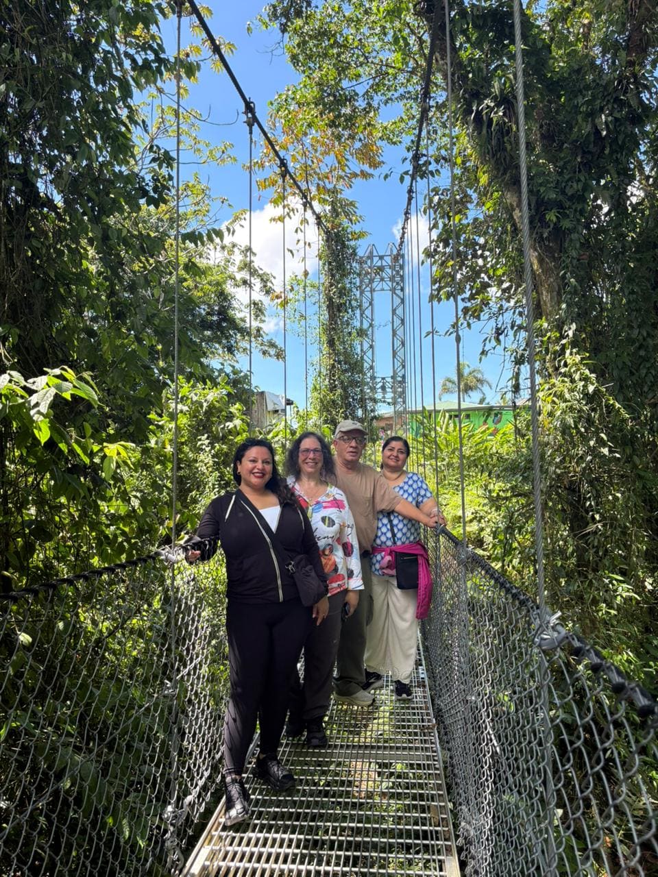 Small group crossing a hanging bridge at Mistico, Arenal
