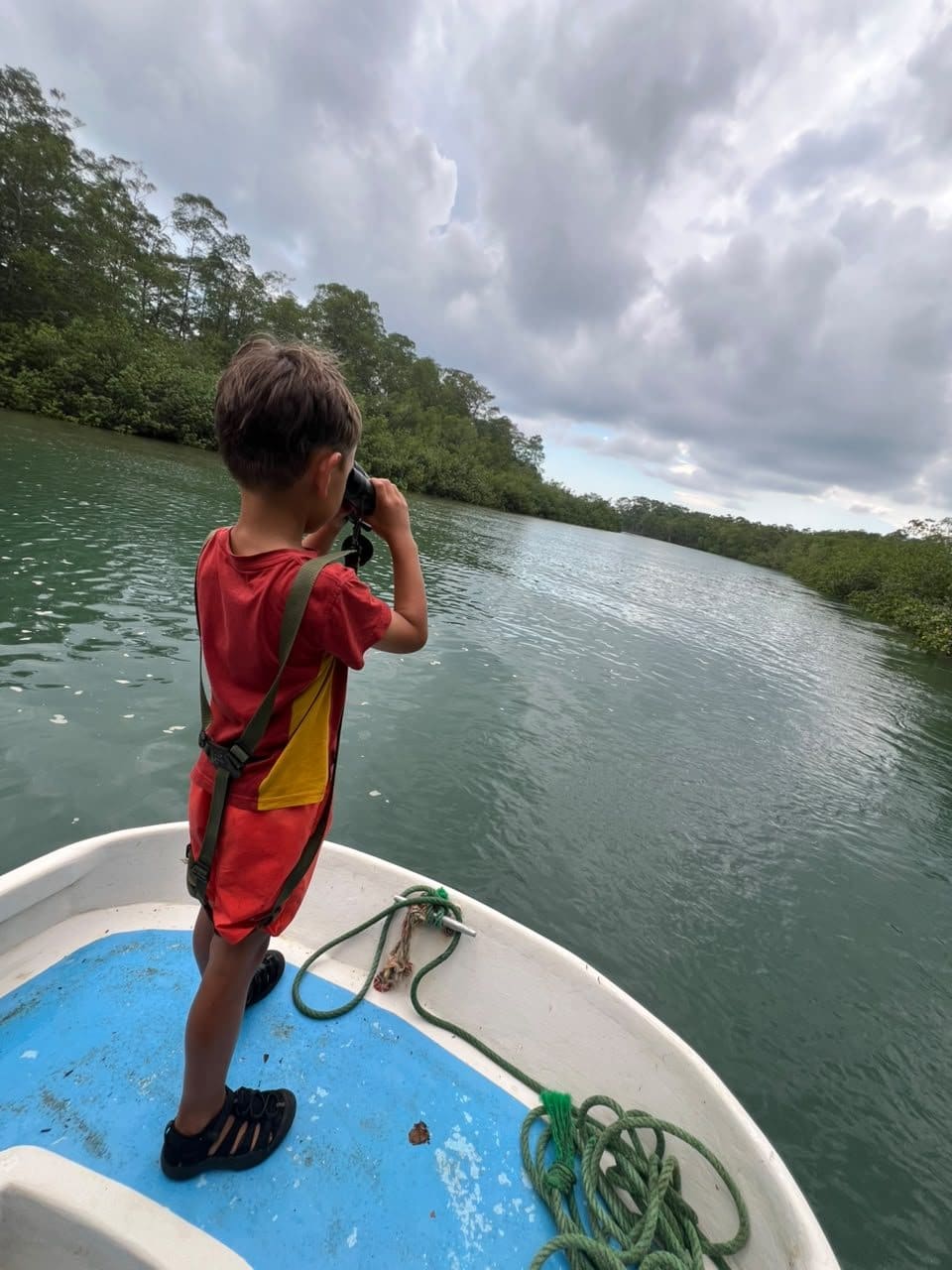 Young guest photographing wildlife from the boat at Isla Damas